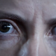 The face of a human from Housemarque’s Returnal running on a PS5.
